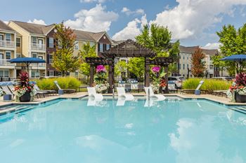 A pool with a fountain in the middle of it